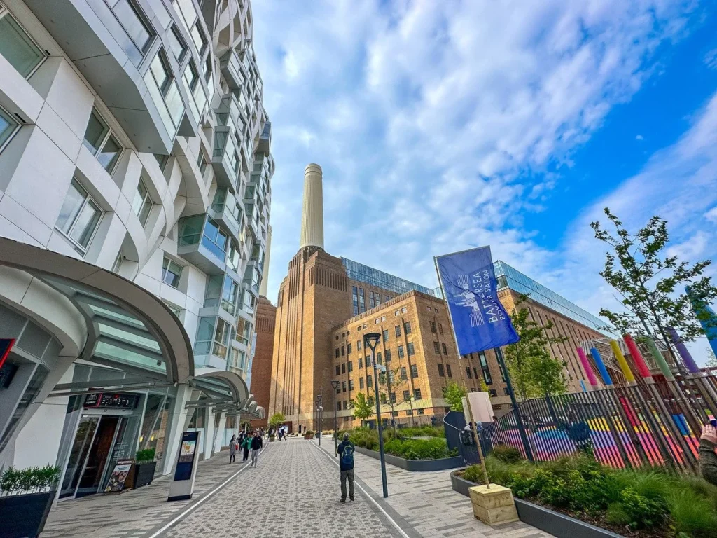 Battersea Power Station with modern residential developments beside it, showing restored industrial architecture alongside new riverside apartments in South West London