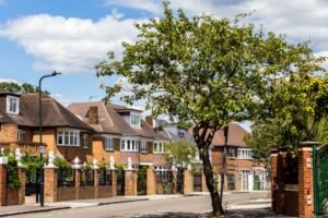 Brondesbury residential street in North West London with Victorian houses, parked cars and tree-lined surroundings