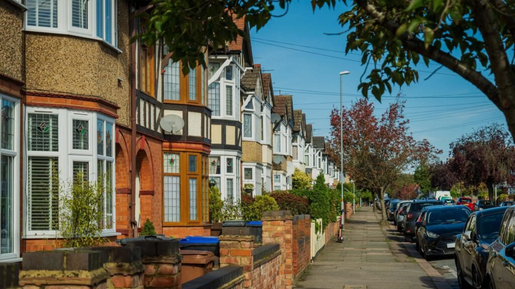 Residential street in London with traditional terraced houses and parked cars, typical of areas where house removals take place across the city